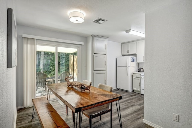 dining space with wood-type flooring