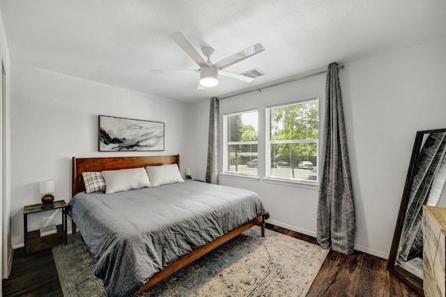 bedroom with ceiling fan and dark hardwood / wood-style flooring