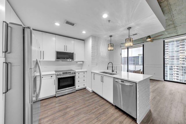 kitchen featuring white cabinetry, stainless steel appliances, and sink