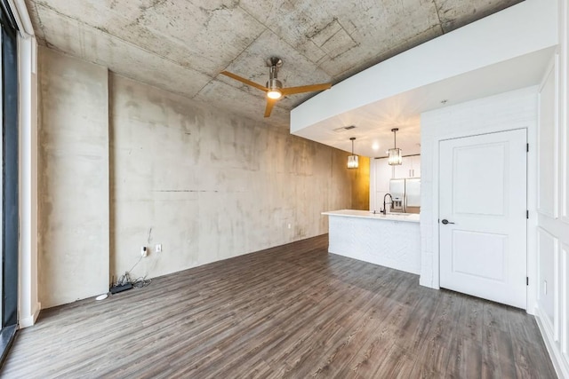 interior space with dark wood-type flooring and ceiling fan