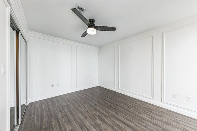 unfurnished bedroom featuring dark wood-type flooring and ceiling fan