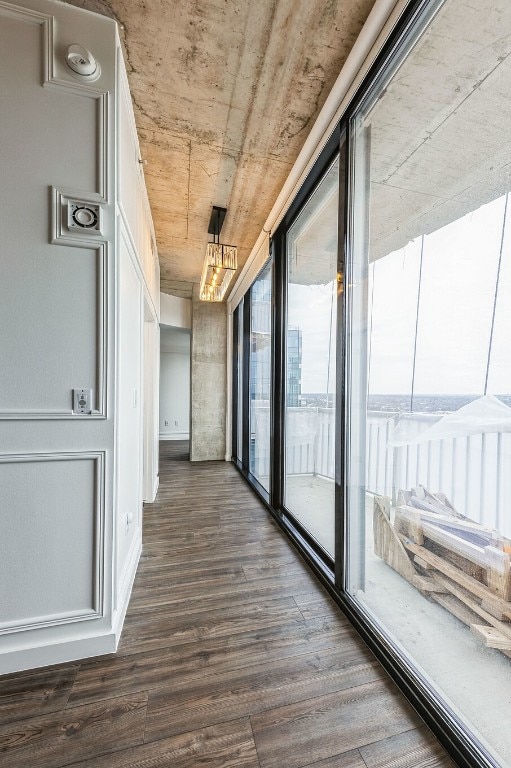 corridor with dark hardwood / wood-style flooring and wooden ceiling