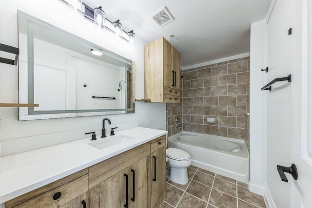 full bathroom with tile patterned floors, toilet, tiled shower / bath combo, and vanity