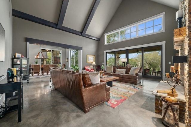 living area with concrete flooring, high vaulted ceiling, and beamed ceiling