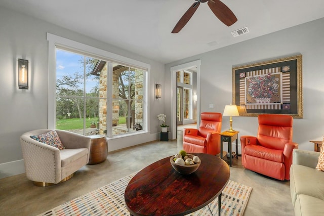 living area featuring ceiling fan and visible vents