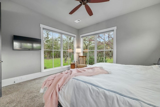 bedroom featuring carpet floors, visible vents, and ceiling fan