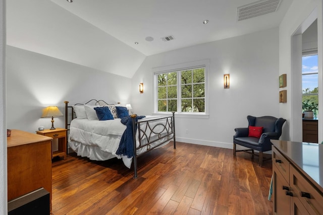 bedroom featuring baseboards, visible vents, vaulted ceiling, and dark wood-type flooring