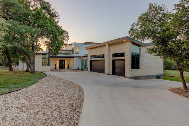 modern home with a garage and a lawn