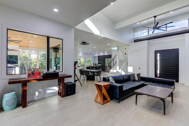 living room with ceiling fan, a healthy amount of sunlight, and light hardwood / wood-style floors