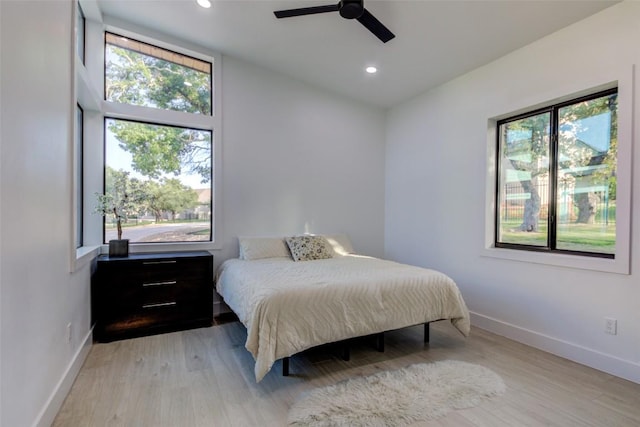 bedroom with vaulted ceiling, light hardwood / wood-style floors, and ceiling fan