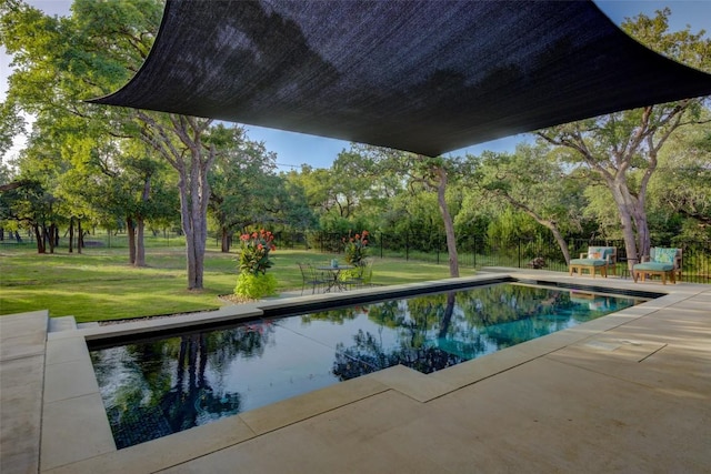 view of pool featuring a yard and a patio area