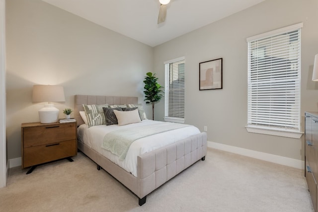 bedroom with light carpet, vaulted ceiling, and ceiling fan