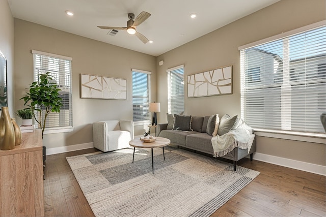 living room featuring dark hardwood / wood-style floors and ceiling fan