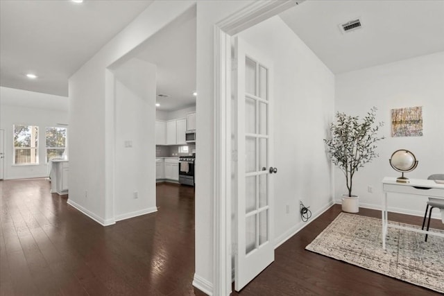 hall with dark hardwood / wood-style flooring