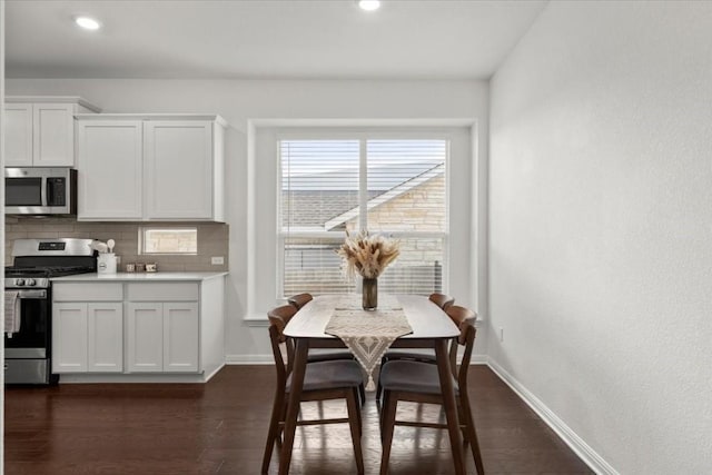 dining area featuring dark wood-type flooring