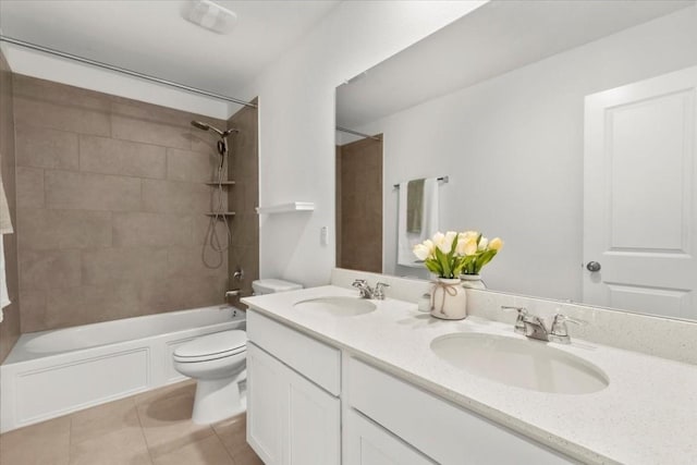 full bathroom with tiled shower / bath, vanity, toilet, and tile patterned flooring