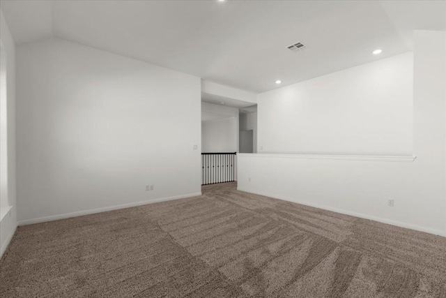 unfurnished room with vaulted ceiling and carpet