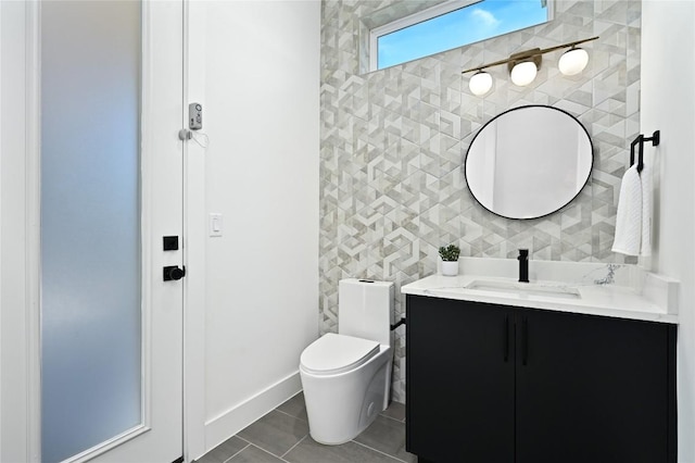 bathroom featuring vanity, tile patterned floors, and toilet