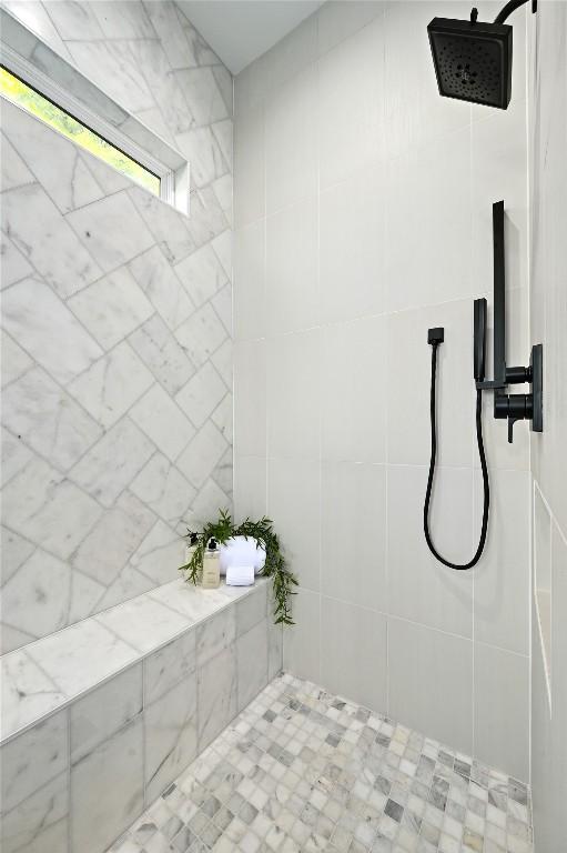 bathroom with a tile shower