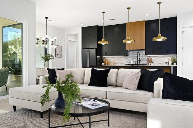 living room with sink and an inviting chandelier