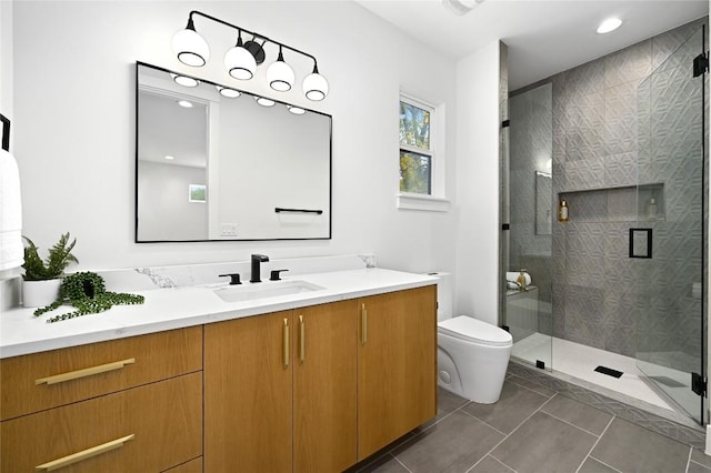 bathroom with tile patterned floors, vanity, toilet, and a shower with shower door