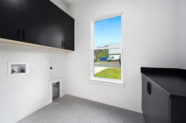 washroom with washer hookup, cabinets, and hookup for an electric dryer