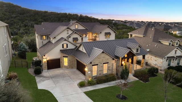 view of front of property with a garage and a yard