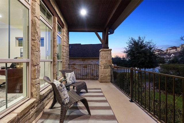 view of balcony at dusk