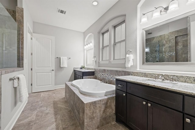 bathroom featuring vanity and separate shower and tub