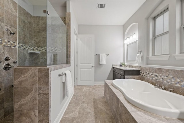 bathroom with vanity and separate shower and tub