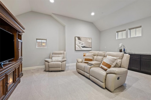 carpeted living room featuring vaulted ceiling