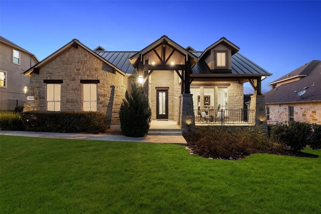 view of front of property featuring a lawn and a porch