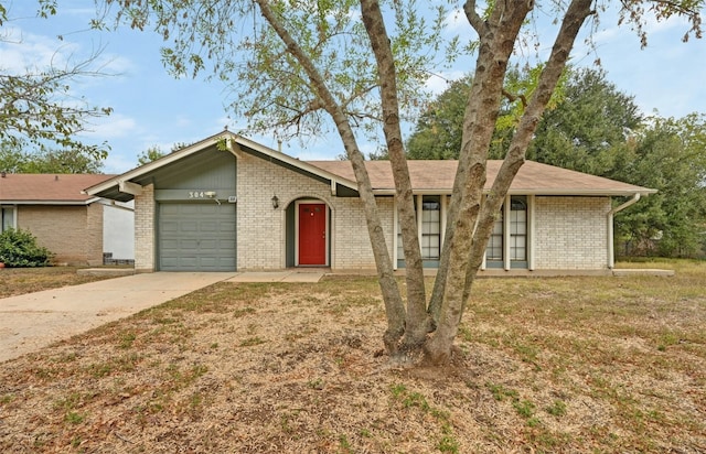 ranch-style home featuring a garage and a front yard