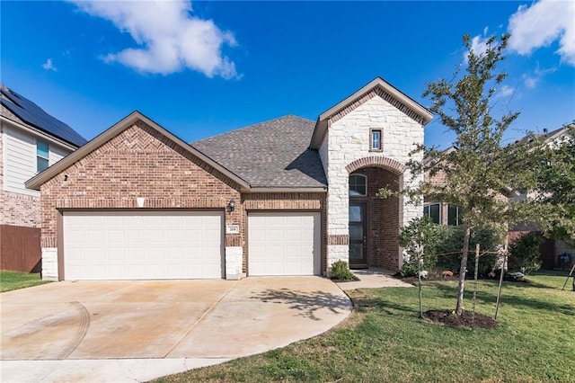 view of front of home with a garage and a front yard