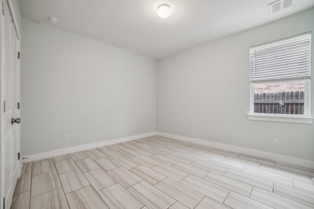 spare room featuring visible vents and baseboards