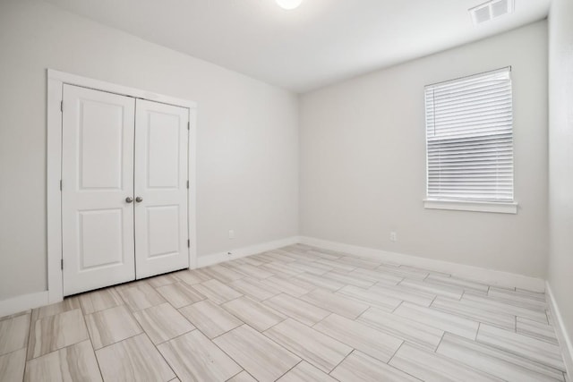 spare room with visible vents and baseboards