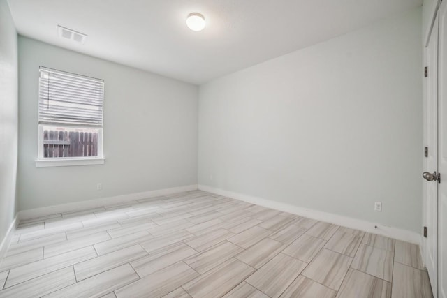 unfurnished room featuring visible vents and baseboards