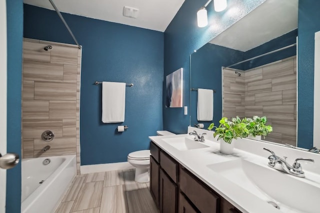 full bathroom with baseboards, a sink, toilet, and shower / bathtub combination