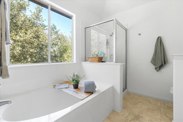 bathroom featuring separate shower and tub