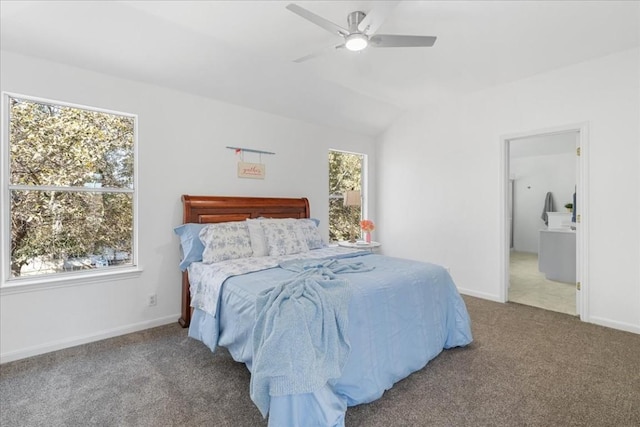 bedroom featuring multiple windows, carpet floors, ensuite bathroom, and vaulted ceiling