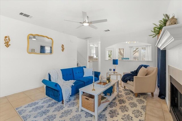 311 Juniper Dr, Georgetown, TX 78626 - tiled living area featuring a ceiling fan, visible vents, stairway, and a fireplace