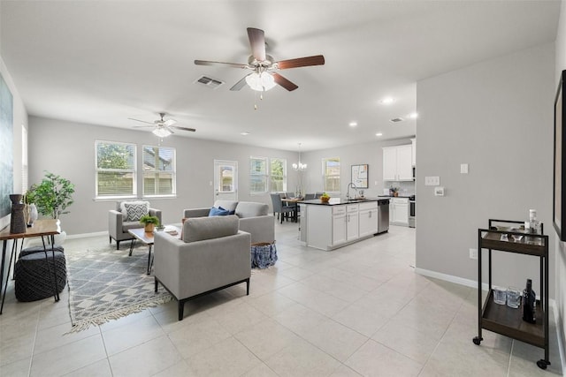 living room featuring light tile patterned floors, sink, and ceiling fan