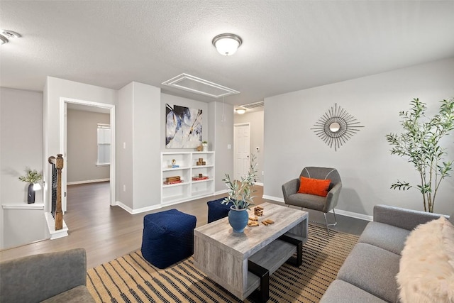 living room with dark hardwood / wood-style floors and a textured ceiling