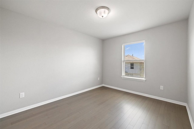 empty room with dark hardwood / wood-style floors