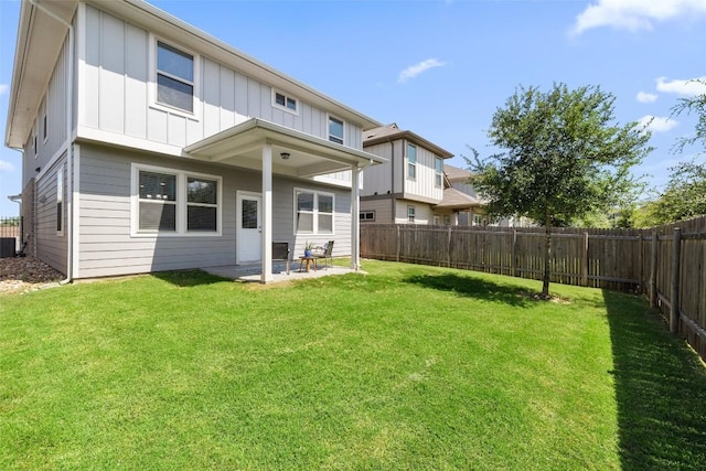 back of property featuring cooling unit, a lawn, and a patio area