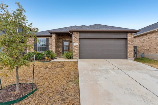 view of front of house featuring a garage and a front lawn