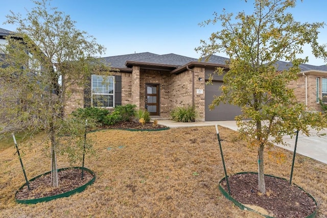 view of front of home with a garage and a front yard