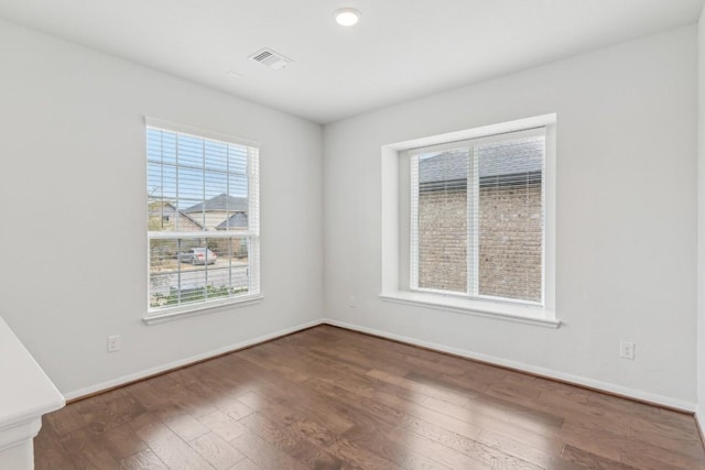 unfurnished room with dark hardwood / wood-style flooring