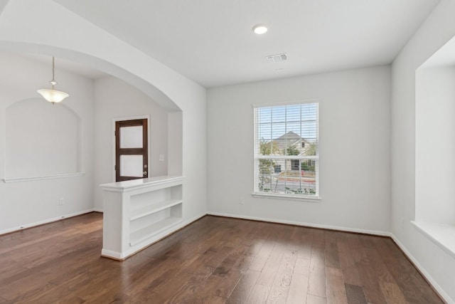 empty room with dark hardwood / wood-style floors