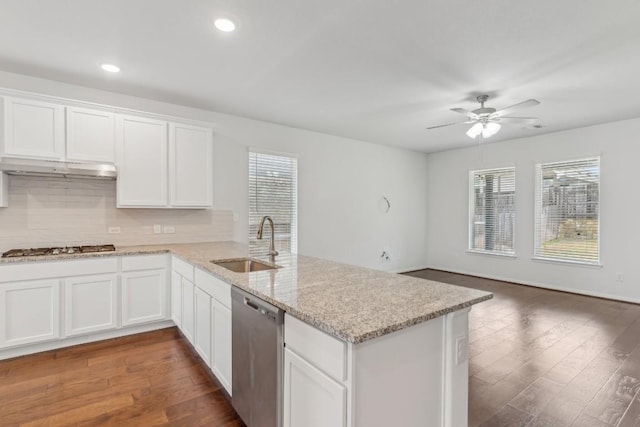 kitchen featuring stainless steel appliances, kitchen peninsula, sink, and white cabinets